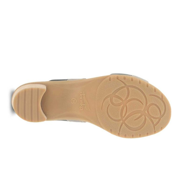 The Dansko Womens Theresa Black sandal by DANSKO has a beige sole with a low heel, a circular swirl pattern on the ball of the foot, and the DANSKO logo at the center—ideal for reducing foot pain.