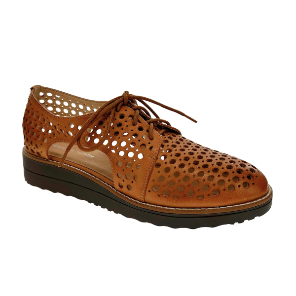 The Django & Juliette Womens Onstage Tan Leather shoe by DJANGO & JULIETT features a brown leather lace-up design with a black sole and circular cut-out perforations for breathable, all-day comfort.