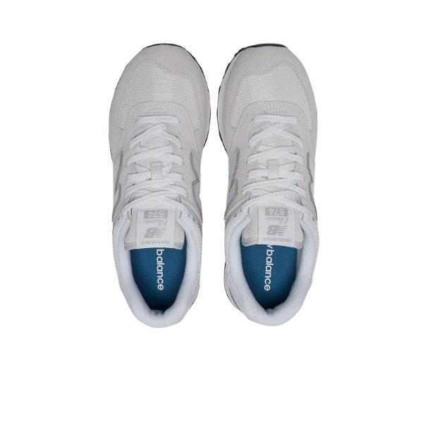 A pair of New Balance Mens 574 White/Grey running shoes are shown from above on a white background, highlighting the tops, laces, and blue insoles with the NEW BALANCE logo. Designed for comfort and foot pain relief.