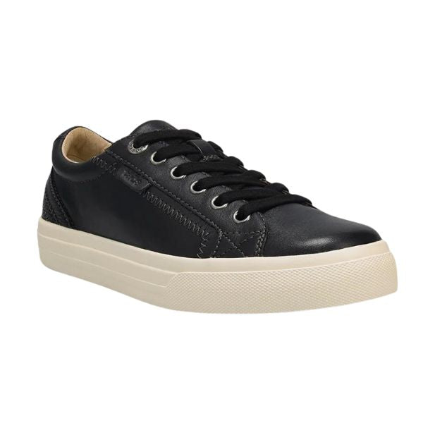 The TAOS Taos Womens Plim Soul Lux Black is a black low-top sneaker with black laces, black stitching, and a thick white sole for enhanced metatarsal support, shown at an angle on a plain white background.