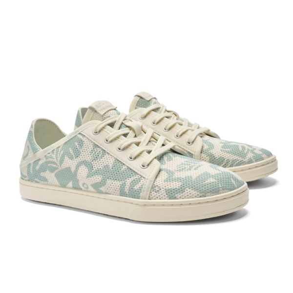 The OLUKAI Womens Pehuea Li Sneakers Offwhite feature casual lace-up styling, an off-white sole, and a light blue and cream floral print on a breathable mesh upper.