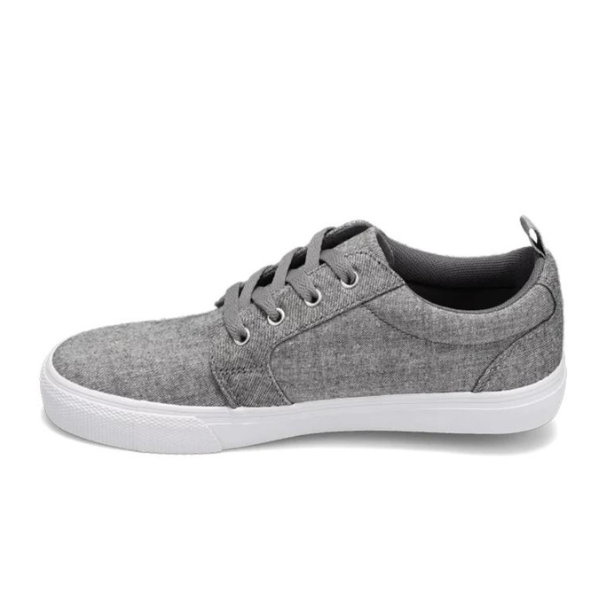 The Rival Womens Tilt Grey Chambray by RIVAL, INC. features a gray canvas upper, white abrasion-resistant rubber outsole, black laces, and a heel pull tab, shown from the side against a white background.