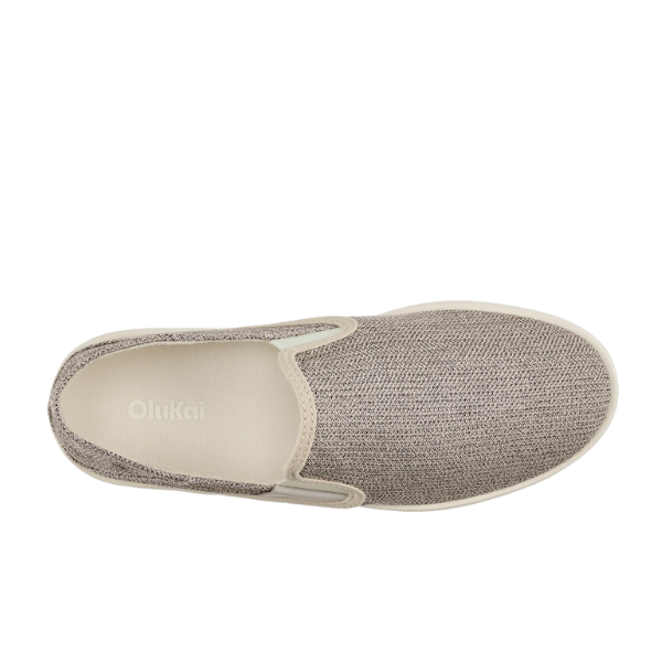 Top view of the OLUKAI Womens Tape Pehuea slip-on shoe with a textured light brown upper, cream sole, OLUKAI logo on the insole, and an anatomical footbed for comfort.