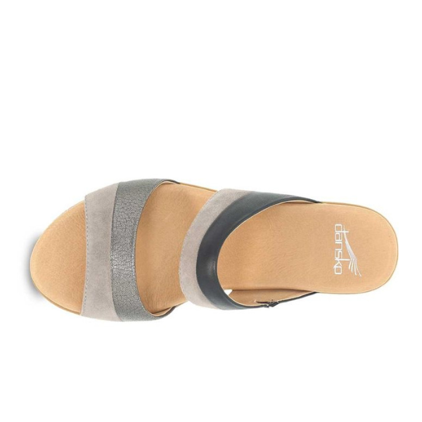 A top view of the Dansko Womens Theresa Black sandal by DANSKO shows two Wide black straps over a tan footbed with a white logo near the heel, designed for comfort and to help alleviate foot pain.