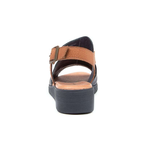 The DJANGO & JULIETT Madis Black Leather sandal features a thick black sole, ankle strap, and buckle, shown from the back against a white background to highlight its comfort-focused design.