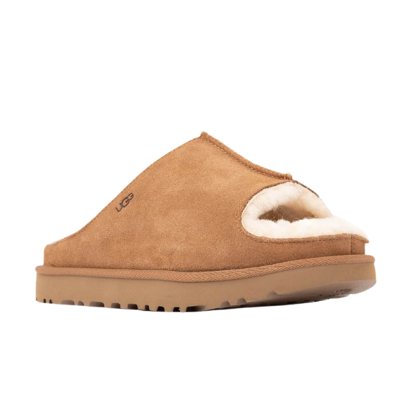The UGG Women's Greenport Slide Chestnut is a tan suede open-toe slipper with a fluffy white lining, rubber sole, and side UGG logo—ideal for cozy indoor-outdoor comfort.