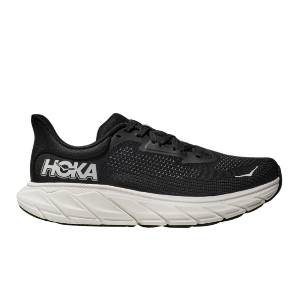 The HOKA Mens Arahi 7 Wide Black/White is a stability shoe with a breathable mesh upper, bold white HOKA logo on the side, a thick white sole, and J-Frame technology for enhanced support.