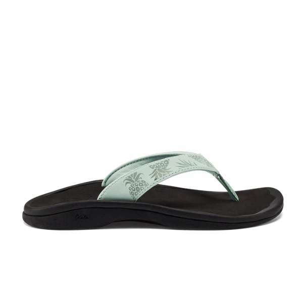 The OLUKAI Womens Ohana Mint / Swell Hua sandal features a mint green tropical-patterned strap and a black anatomical cushioned sole, shown in side profile against a white background.