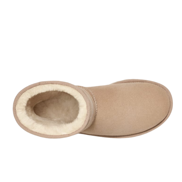 A top view of a single tan suede slipper boot with plush cream lining, inspired by UGG Womens Classic Short II Boots Sand by UGG, perfect for soothing foot pain comfort.