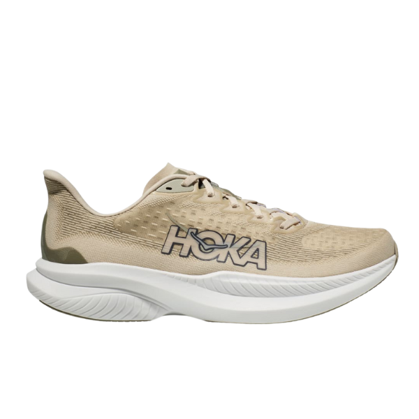 The HOKA Mens Mach 6 (Medium Width) in Beige/Oatmilk Barley features a textured mesh upper, black and white HOKA logo, and thick cushioned sole—ideal for everyday running and designed to help reduce foot pain.