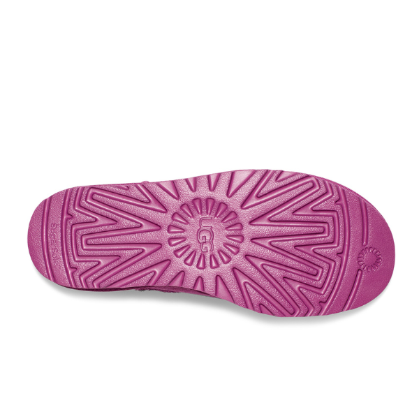 The image features the sole of the UGG Womens Classic Ultra Mini Boot in purple, displaying a geometric tread pattern with UGG embossed at the center.