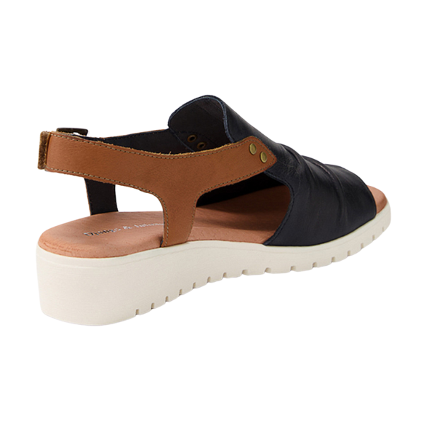 The DJANGO & JULIETTE Womens Madis sandal in navy/tan leather features a stylish open back, low wedge heel, and comfortable design for effortless wear and foot pain relief.