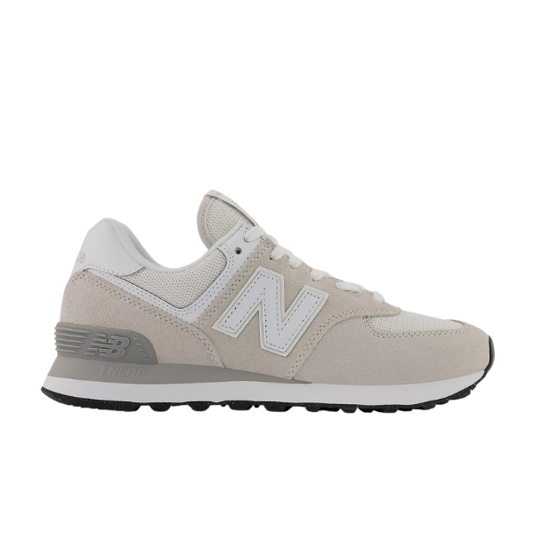 The New Balance Womens 574 Core White/Grey features a mesh and suede upper, white laces, distinctive N branding, and a gray heel accent for versatile style and classic comfort.