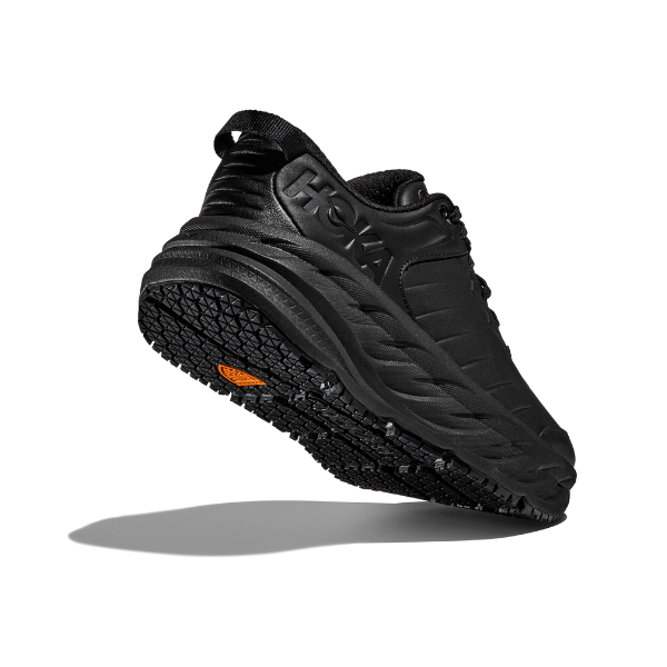 The HOKA Womens Bondi SR Wide Black is an athletic shoe featuring a thick, textured, slip-resistant outsole with an orange accent, shown angled on a white background with a shadow for depth.