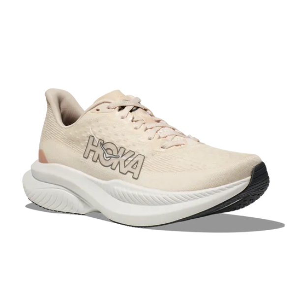 The HOKA Womens Mach 6 (Wide Width) Vanilla is a beige running shoe with a cushioned white and gray sole, black outsole, and bold side logo—perfect for daily runs and reducing foot pain. Displayed on a white background.