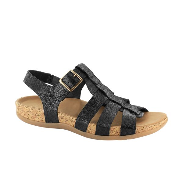 The Strive Womens Cristal Black Leather by STRIVE is a black strappy gladiator sandal with a cork-textured sole, gold buckle, low wedge heel, and memory foam footbed for comfortable casual wear.
