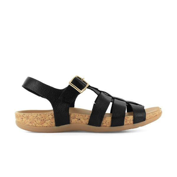 The Strive Womens Cristal Black Leather sandal by STRIVE features a gladiator style, cork-textured sole, tan rubber outsole, memory foam footbed, and an adjustable gold buckle at the ankle.