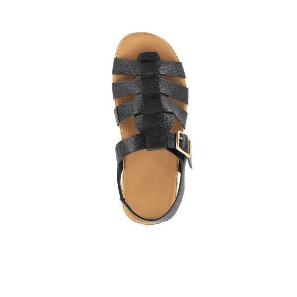 Top view of the Strive Womens Cristal Black Leather sandal by STRIVE, featuring a black gladiator design, tan memory foam footbed, and adjustable side buckle, shown on a white background.