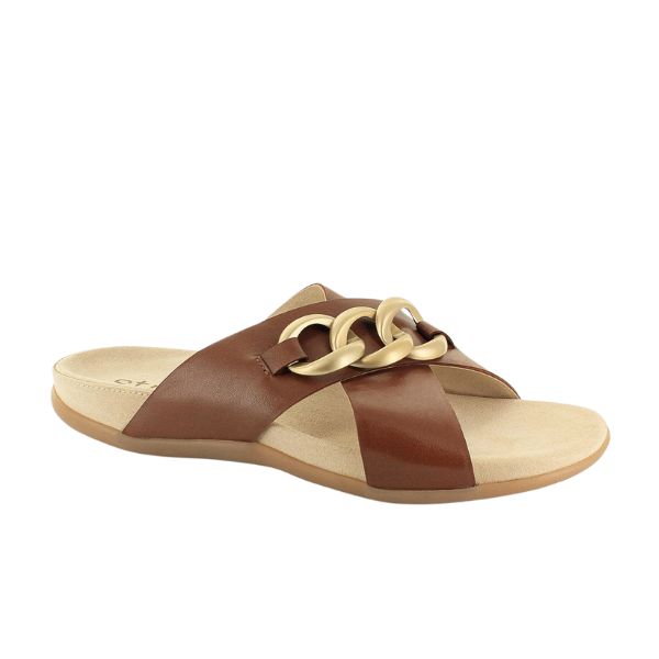The STRIVE Strive Womens Palma Link Tan is a brown leather slide sandal featuring crisscross straps and a bold gold chain-link detail, set on a beige sole with Biomechanical Footbed Technology for superior comfort and support.