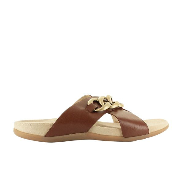 The STRIVE Strive Womens Palma Link Tan sandal features crisscross tan leather straps, a bold gold chain accent, and a cushioned beige sole with memory foam footbed for exceptional comfort and support.