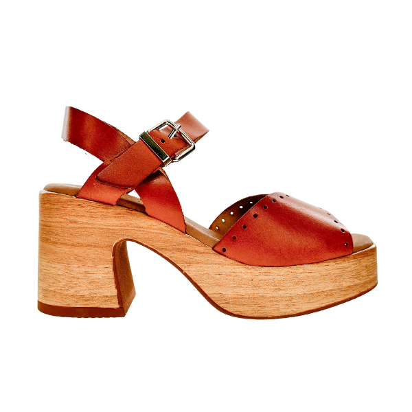 The SOVELLA Sovella Womens Lucia Tan is a tan leather platform sandal with a chunky wooden heel, supportive footbed, ankle strap with silver buckle, open toe, and decorative perforations on its lightweight design.