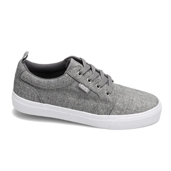 The Rival Womens Tilt Grey Chambray sneaker by RIVAL, INC. features a grey canvas upper, white abrasion-resistant rubber outsole, grey laces, and a small branded side tag, displayed against a white background.