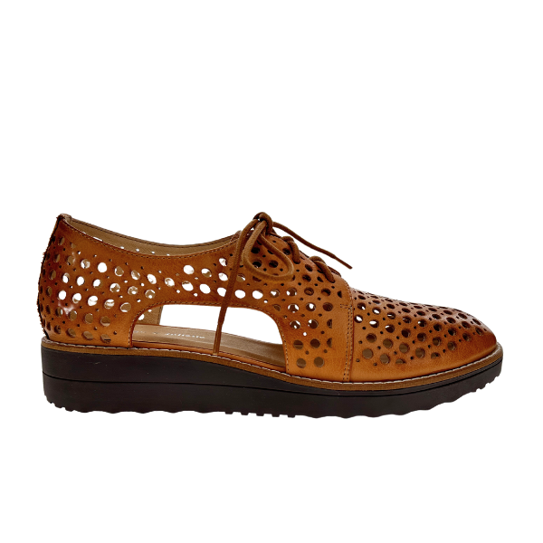 The DJANGO & JULIETTE Womens Onstage Tan Leather lace-up shoe features circular cut-outs, open side panels, and a low black platform sole, combining style and comfort—ideal for those seeking fashionable comfort.