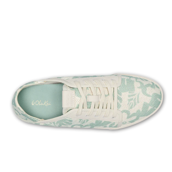 Top view of the OLUKAI Womens Pehuea Li Sneakers in Offwhite, featuring a nature-inspired light green and white pattern, breathable mesh upper, white laces, and a mint green insole with “OluKai” branding.