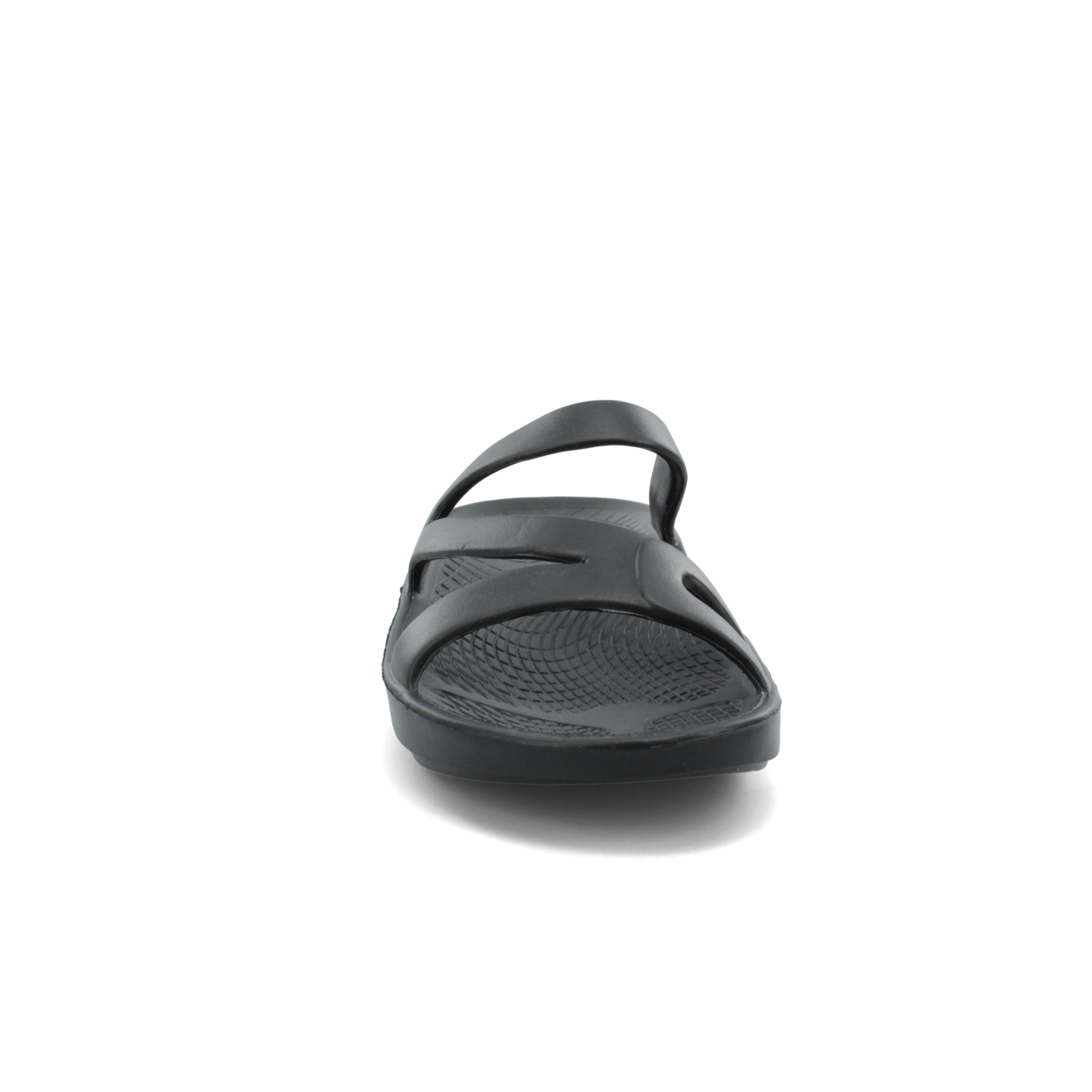 The SOVELLA Sovella Women's PF Slide Black sandal features a front view with two straps and a textured footbed for comfortable cushioning, all shown against a plain light gray background.