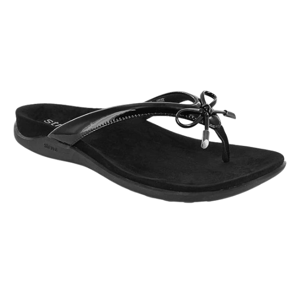 The STRIVE Strive Womens Island Black sandal features a flat sole, thin straps, and a decorative bow. With Biomechanical Footbed Technology™ for arch support, this open-toe style provides comfort and casual chic for warm weather.