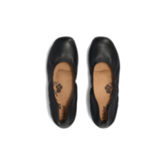 A pair of Taos Womens Chit Chat Black skimmer flats by TAOS, shown from above. They feature black leather, tan insoles with a floral pattern, branded heels, and Arch & Metatarsal Support for all-day comfort.