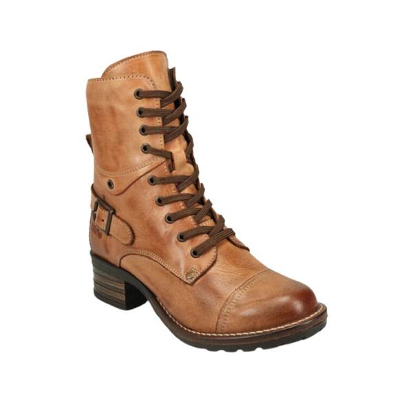 The Taos Womens Crave Boot in Caramel by TAOS features tan leather, a low stacked heel, dark brown sole, decorative side buckle, and orthotic-friendly support. Shown as a single boot against a white background.