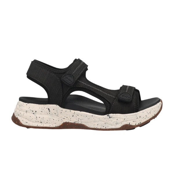 The TAOS Taos Womens Super Side Black sandal features adjustable straps, a thick white speckled sole, and an all-terrain rubber outsole—ideal for outdoor activities with its rugged design.