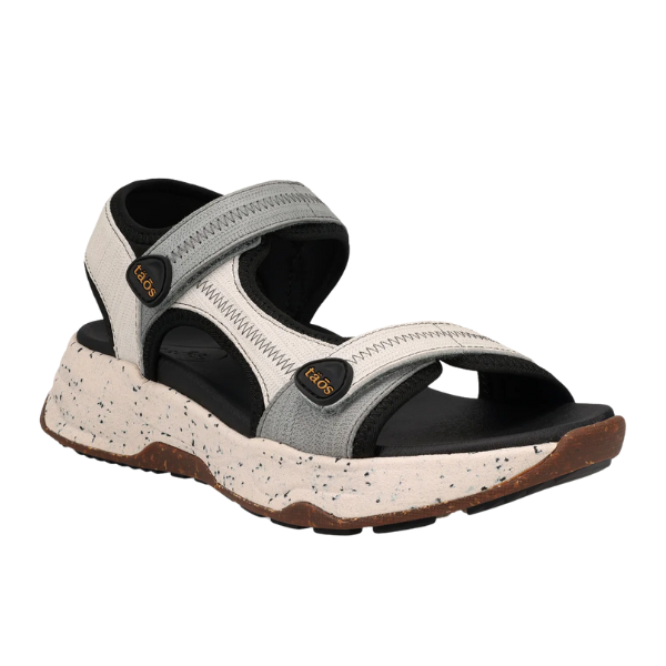 The TAOS Taos Womens Super Side Dove Multi sandal features a light gray and black design with adjustable Velcro straps, a speckled thick sole, supportive footbed, and TAOS branding on the side straps.