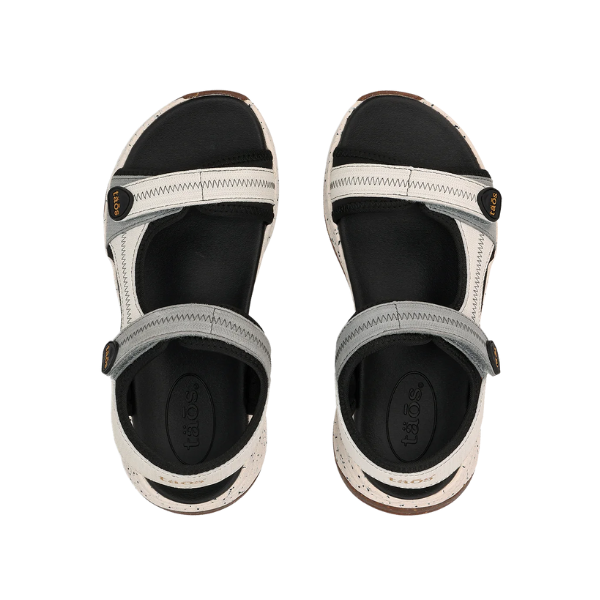 The TAOS Taos Womens Super Side Dove Multi sandals feature black soles, adjustable white and gray straps, and a supportive footbed, shown from above against a white background.