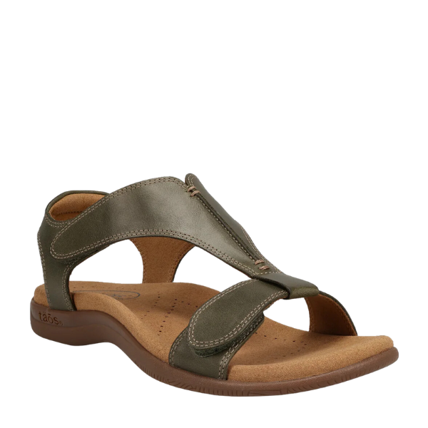 The Taos Womens The Show Olive sandal by TAOS features adjustable olive leather straps, a tan cushioned insole with arch and metatarsal support, open toe and heel, and a low brown rubber sole.