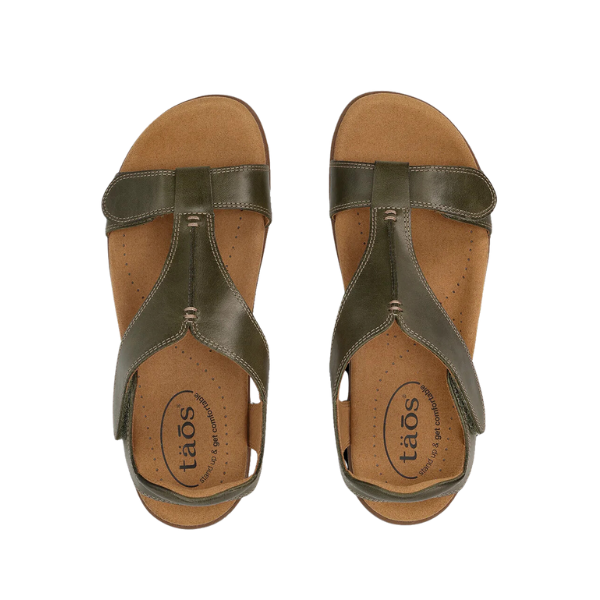 A pair of TAOS Womens The Show Olive sandals with tan cushioned insoles, antimicrobial footbed, and open toes, viewed from above on a white background.