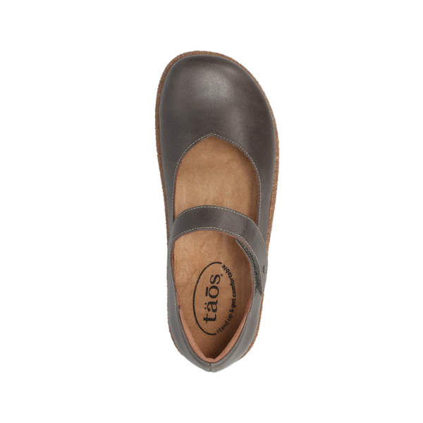 Top view of the TAOS Womens Ultimate Grey Mary Jane shoe, featuring a rounded toe, instep strap, tan cushioned insole, and stylish European leather orthopedic design. Brand name is visible on the shoe.