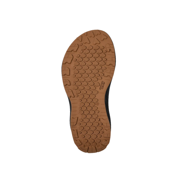 The image shows the brown, textured sole of the Teva Womens Hydratrek Sandal Black/Purple, featuring geometric tread patterns made from recycled Spider Rubber, on a white background.