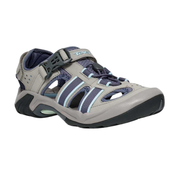 The Teva Womens Omnium 2 Slate is a sporty, closed-toe sandal in light gray and blue with cutouts, a quick-drying upper, rugged Spider Rubber black sole, and an adjustable top strap labeled Teva.