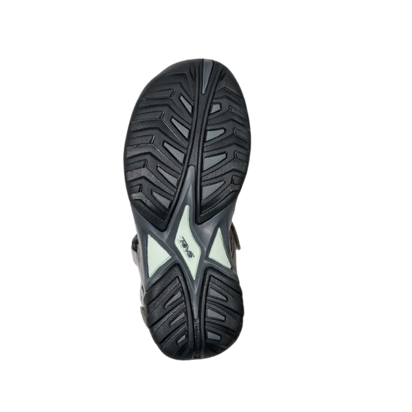 The image features the black Spider Rubber outsole of the Teva Womens Omnium 2 Slate shoe, with a geometric tread and a light logo at the center, displayed against a white background.