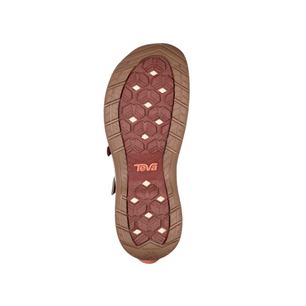 The image shows the brown and red sole of the Teva Womens Tirra CT Mahogany sandal, featuring a hexagonal tread pattern and Teva logo in the center. The background is white.