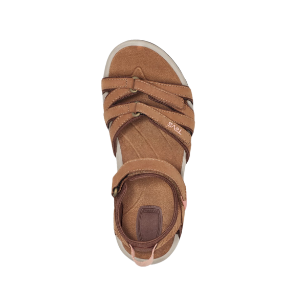 The Teva Womens Tirra Leather Brown sandal features crisscrossing straps and an ankle strap, shown from above on a white background. This Teva design offers comfort and arch support, inspired by the classic Tirra style.