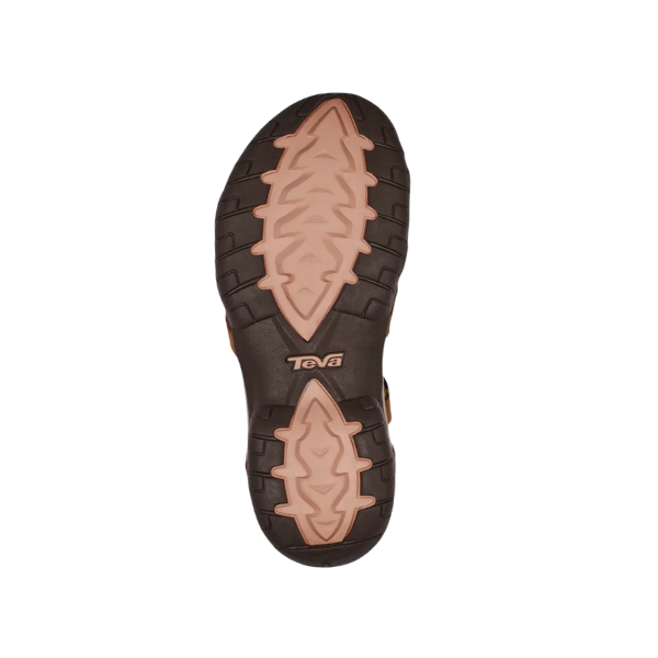 The Teva Womens Tirra Leather Brown sandal features a rugged sole with light tan and dark brown rubber for traction and outdoor use. The Teva logo is centered, and the sole is designed for excellent arch support.