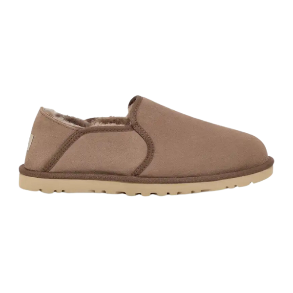The UGG Mens Kenton Caribou slip-on slipper features a plush sheepskin lining, low collapsible heel, and light beige rubber sole. Shown in a side view on a plain white background.