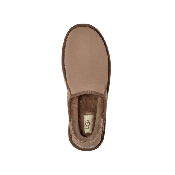 Top view of the UGG Mens Kenton Caribou slipper in tan suede with a brown sole and plush sheepskin lining, featuring a UGG label on the insole. The slipper is centered on a white background.