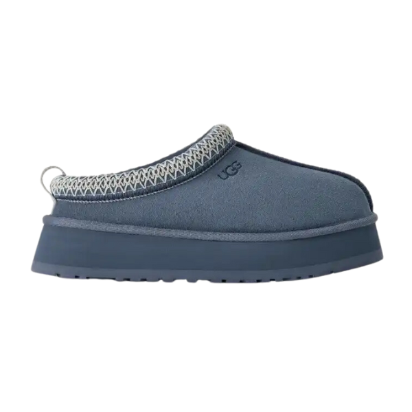 The UGG Womens Tazz Slippers in Desert Blue feature a thick platform sole and patterned ankle trim, combining stylish design with added foot pain relief—shown in side view against a white background.