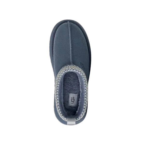 Top view of a single UGG Womens Tazz Slipper in Desert Blue with a plush interior and decorative stitching around the opening, featuring a stylish platform design for women, isolated on a white background.