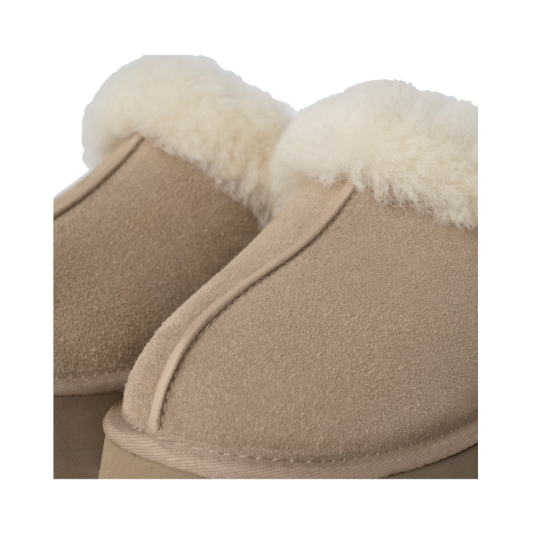 Close-up of UGG Womens Disquette Sand slippers by UGG, highlighting plush white fleece lining at the opening and a retro-inspired platform sole.