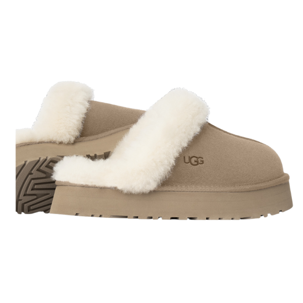 UGG Womens Disquette Sand slipper with sheepskin and suede, thick white lining, matching top strap, retro platform sole, and UGG logo on the side. Shown in a side profile view.